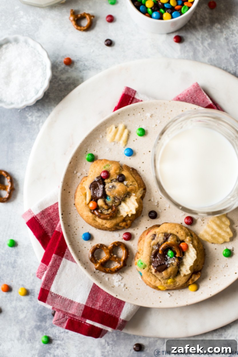 Kitchen Sink Cookies 6 Overhead photo of two warm Kitchen Sink Cookies and a refreshing glass of milk, ready to be enjoyed