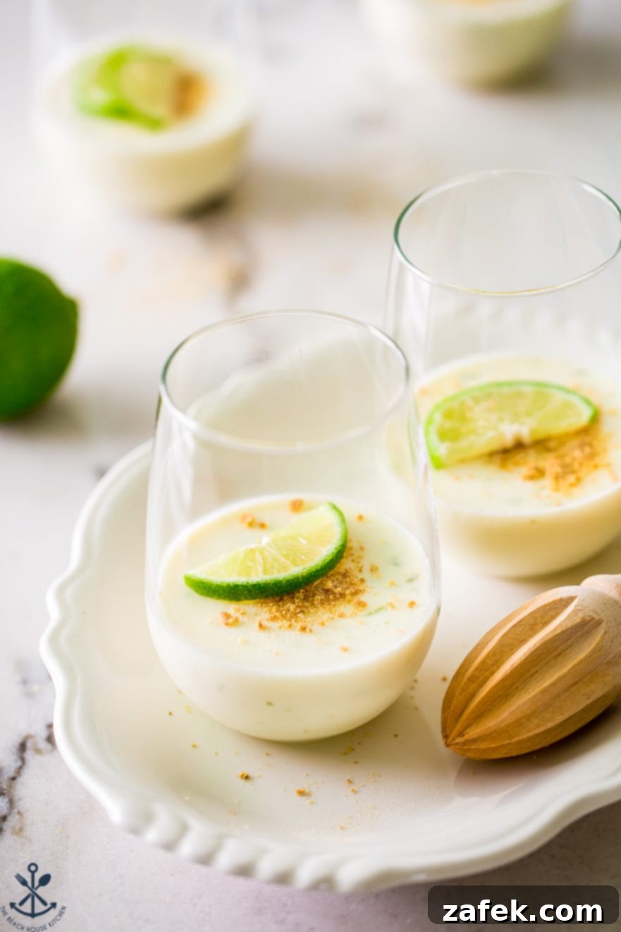 Zesty Key Lime Panna Cotta 4 Two glasses filled with key lime panna cotta on a white oval plate