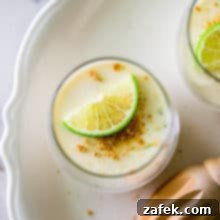 Zesty Key Lime Panna Cotta 7 Overhead photo of a glass filled with panna cotta and a lime slice