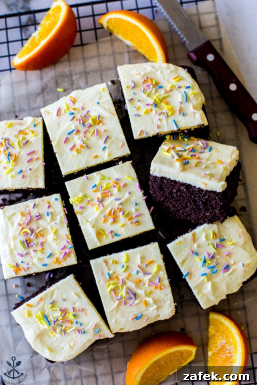 Overhead, up close photo of individual chocolate cake slices with generous orange buttercream, ready to be served
