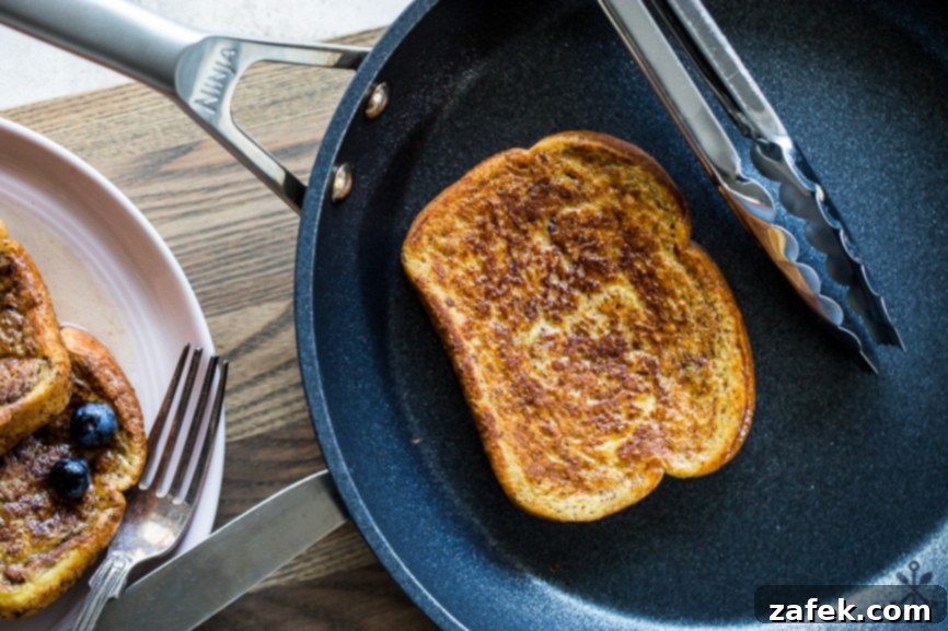 Aromatic Chai French Toast 5 Overhead photo of a slice of french toast in a skillet