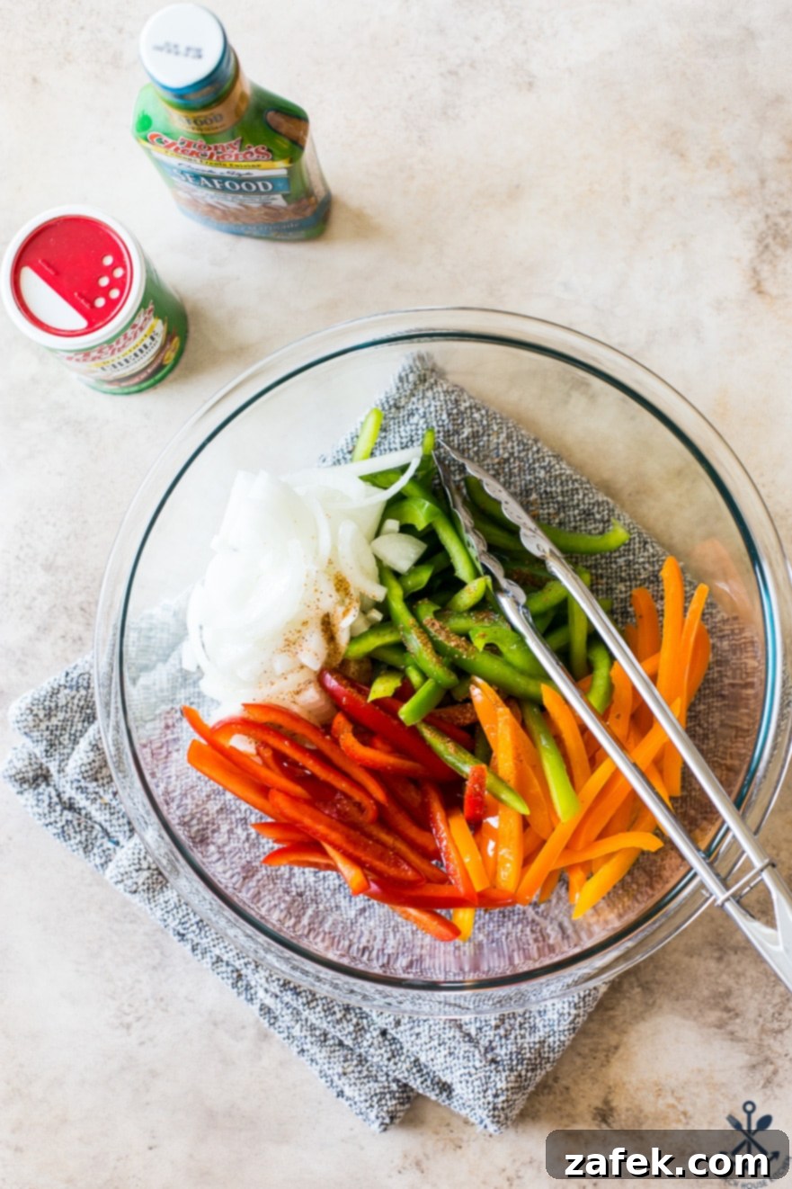 Effortless Sheet Pan Shrimp Fajitas 8 Overhead photo of bowls of onions and peppers in a glass bowl