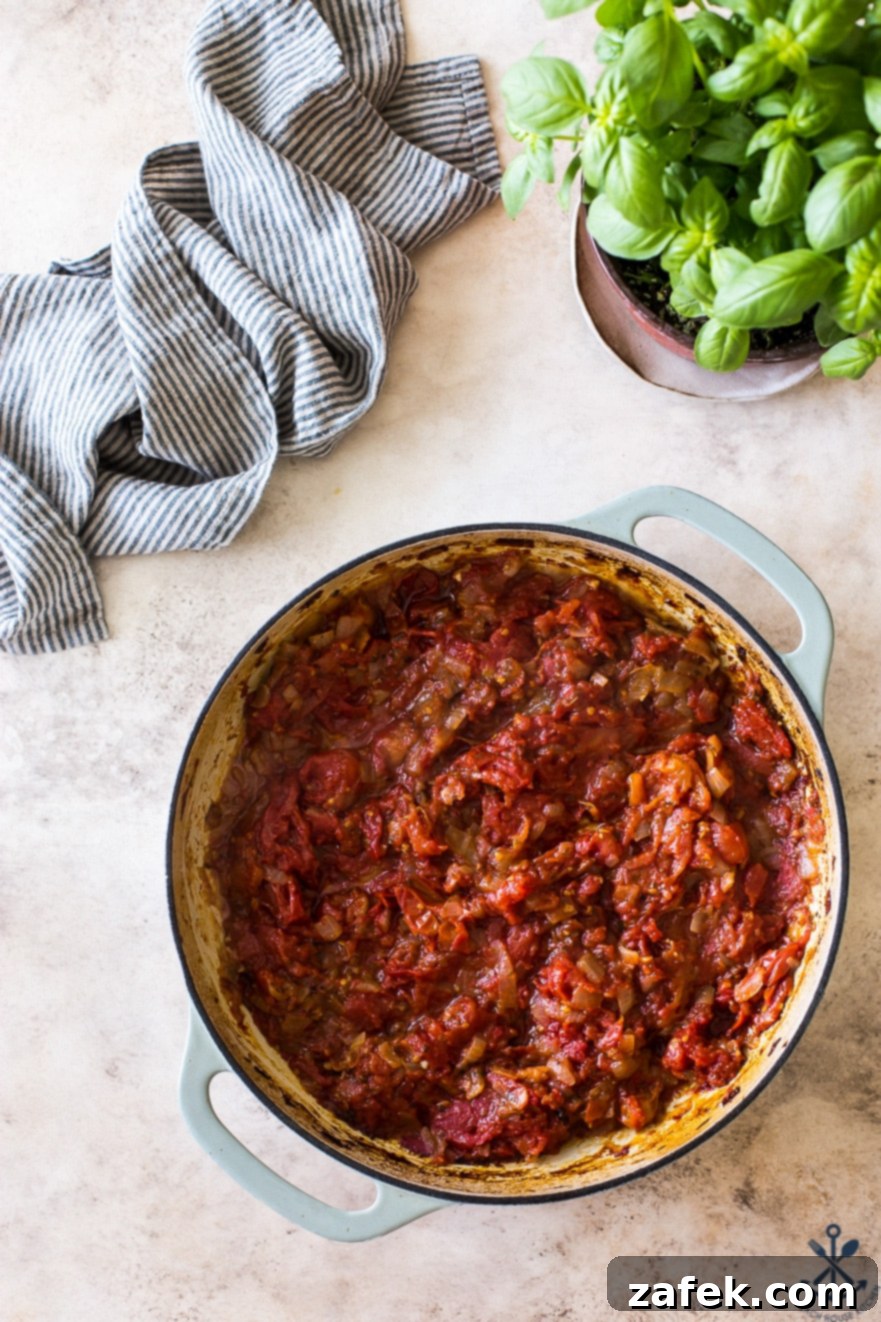 Pink Sauce Penne 7 Overhead photo of a round baking dish filled with the deeply colored and concentrated roasted tomato mixture, radiating rich aromas