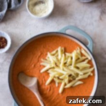 Pink Sauce Penne 9 Overhead photo of a casserole dish filled with Penne alla Vodka, topped with fresh herbs and grated cheese