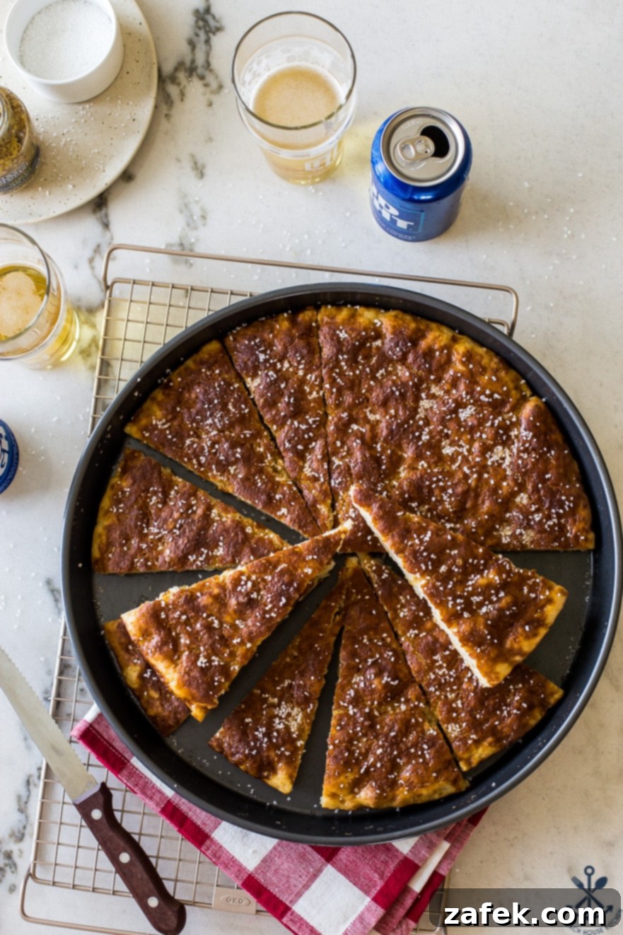 Overhead photo of wedges of pretzel bread in a round baking pan