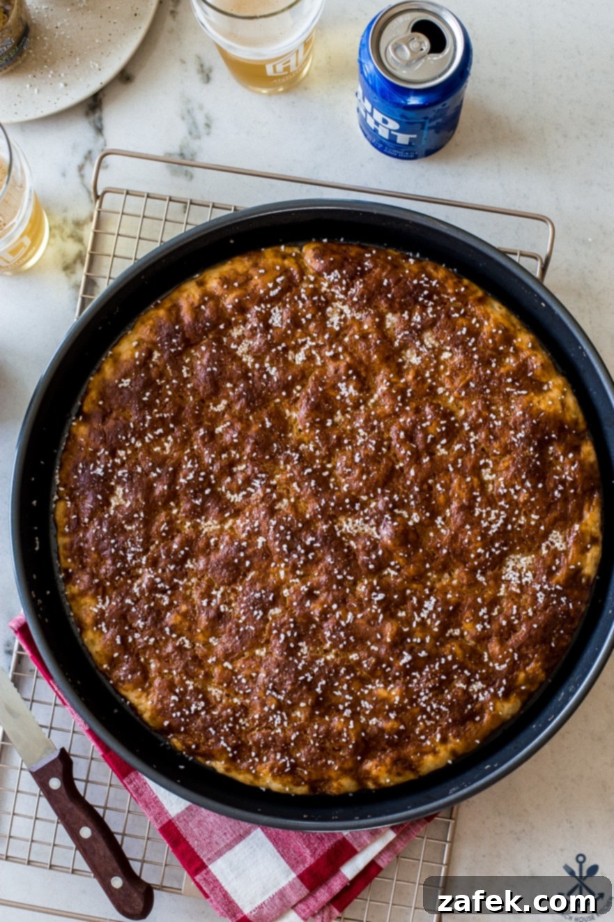 Up close overhead photo of a baking pan of pretzel focaccia