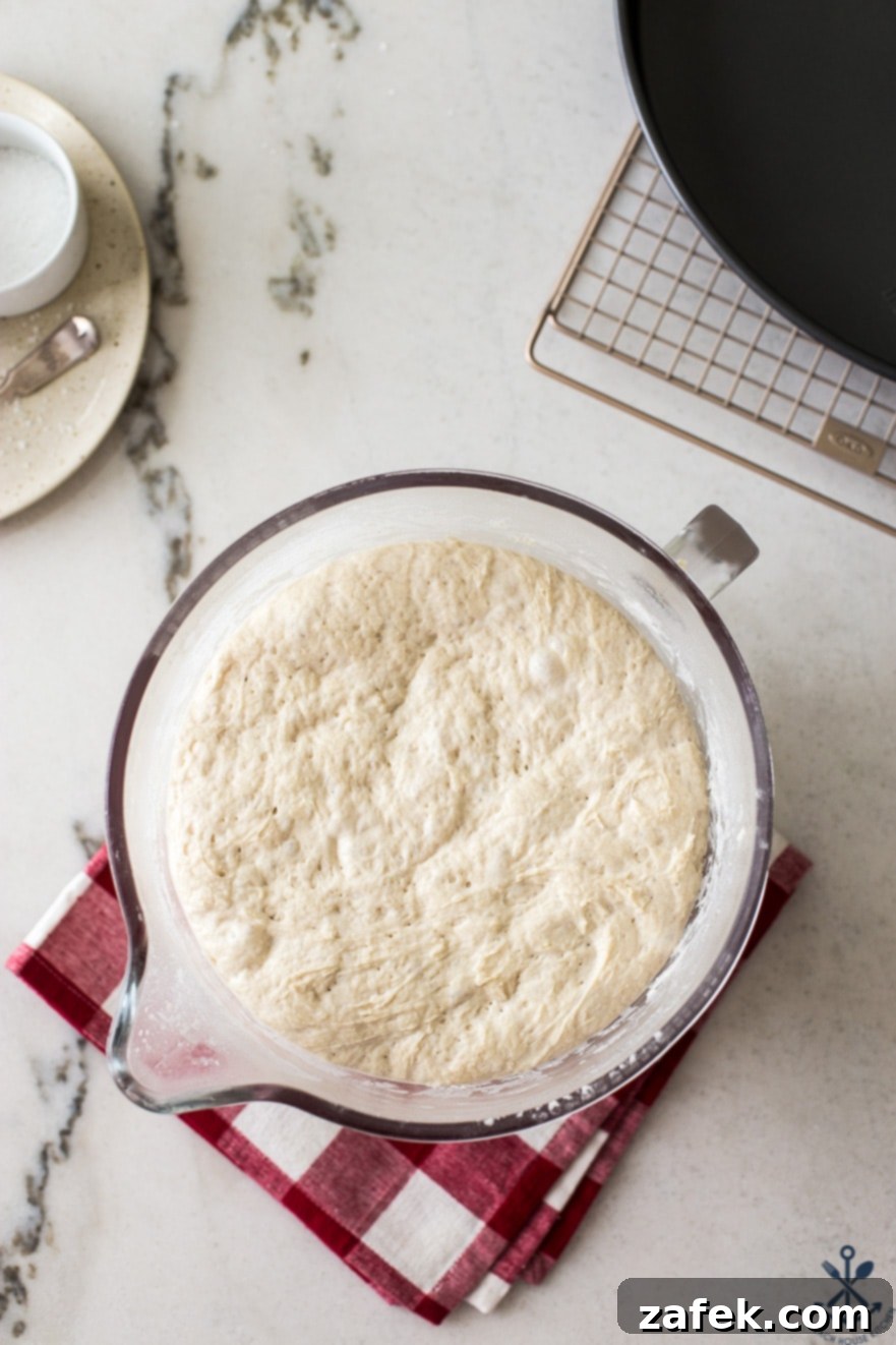 Overhead photo of glass bowl filled with dough