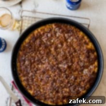 Overhead photo of pretzel focaccia in a round baking pan on a wire rack.