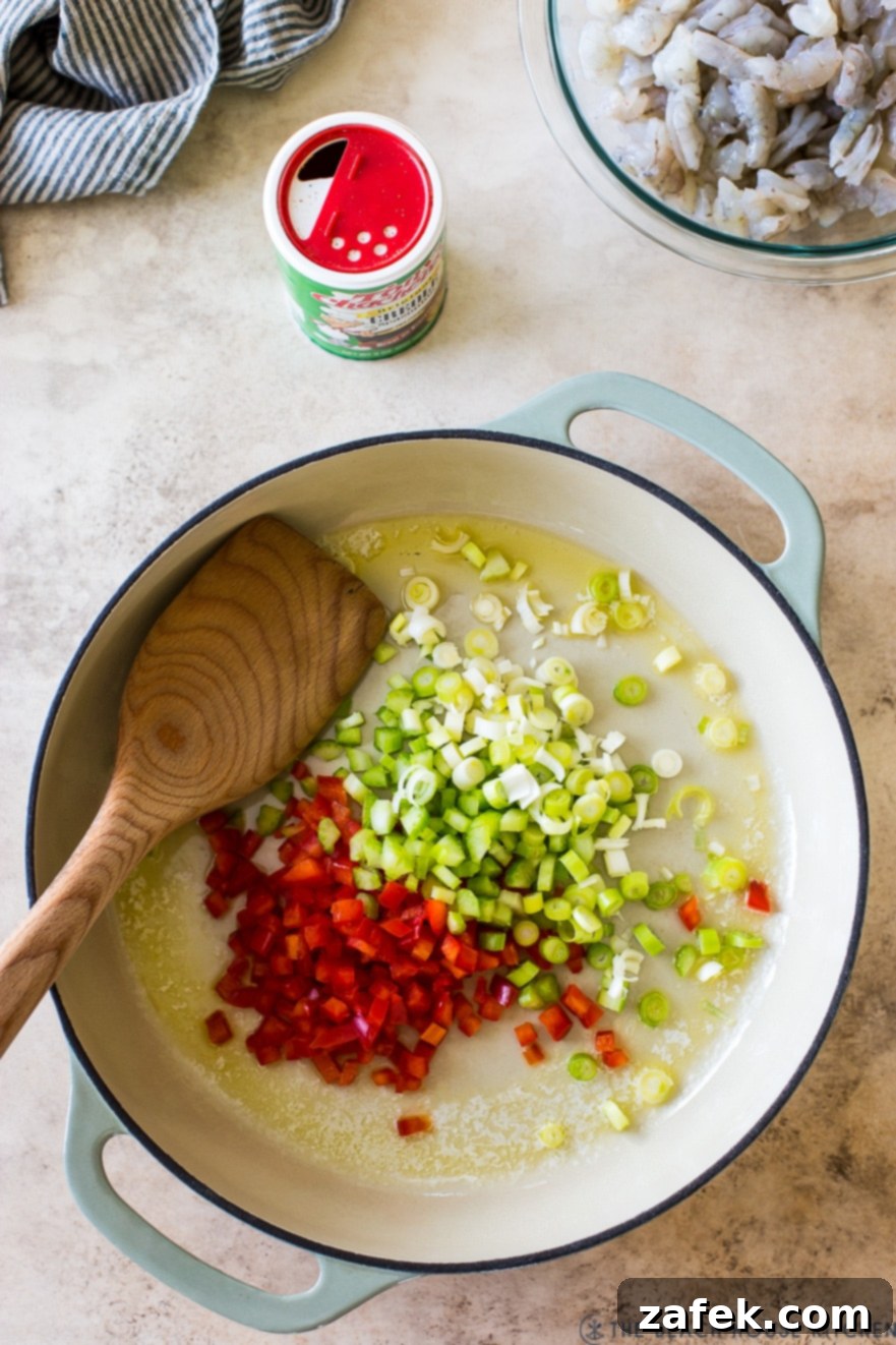 Creole Shrimp Kick 4 Overhead photo of a round baking dish filled with finely chopped red peppers, celery, and green onions.