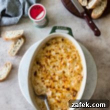 Creole Shrimp Kick 7 Overhead photo of a shrimp dip in an oval dish with baguette slices