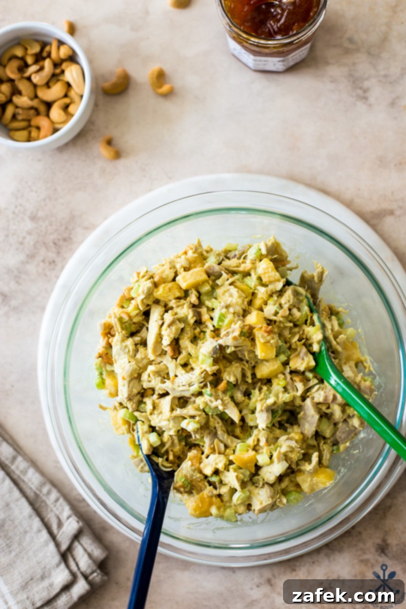 Overhead photo of a bowl filled with freshly prepared curried chicken salad, ready to be served