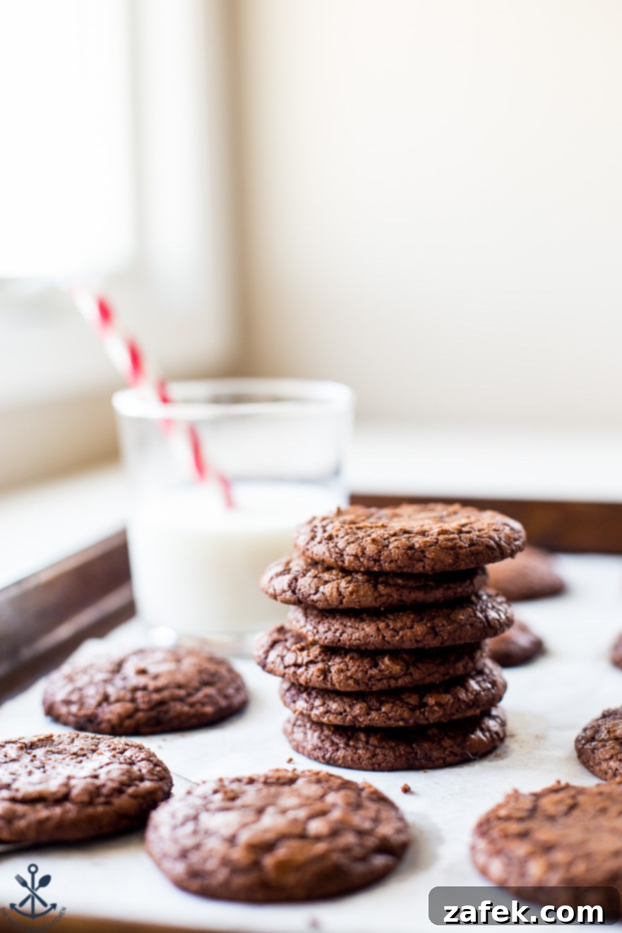 Decadent Fudgy Brownie Cookies 2 A stack of brownie cookies with a glass of milk in the background
