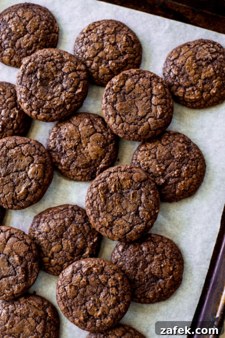 Decadent Fudgy Brownie Cookies 7 Overhead photo of a parchment lined baking sheet of brownie cookies