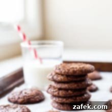Decadent Fudgy Brownie Cookies 8 A stack of brownie cookies with a glass of milk in the background