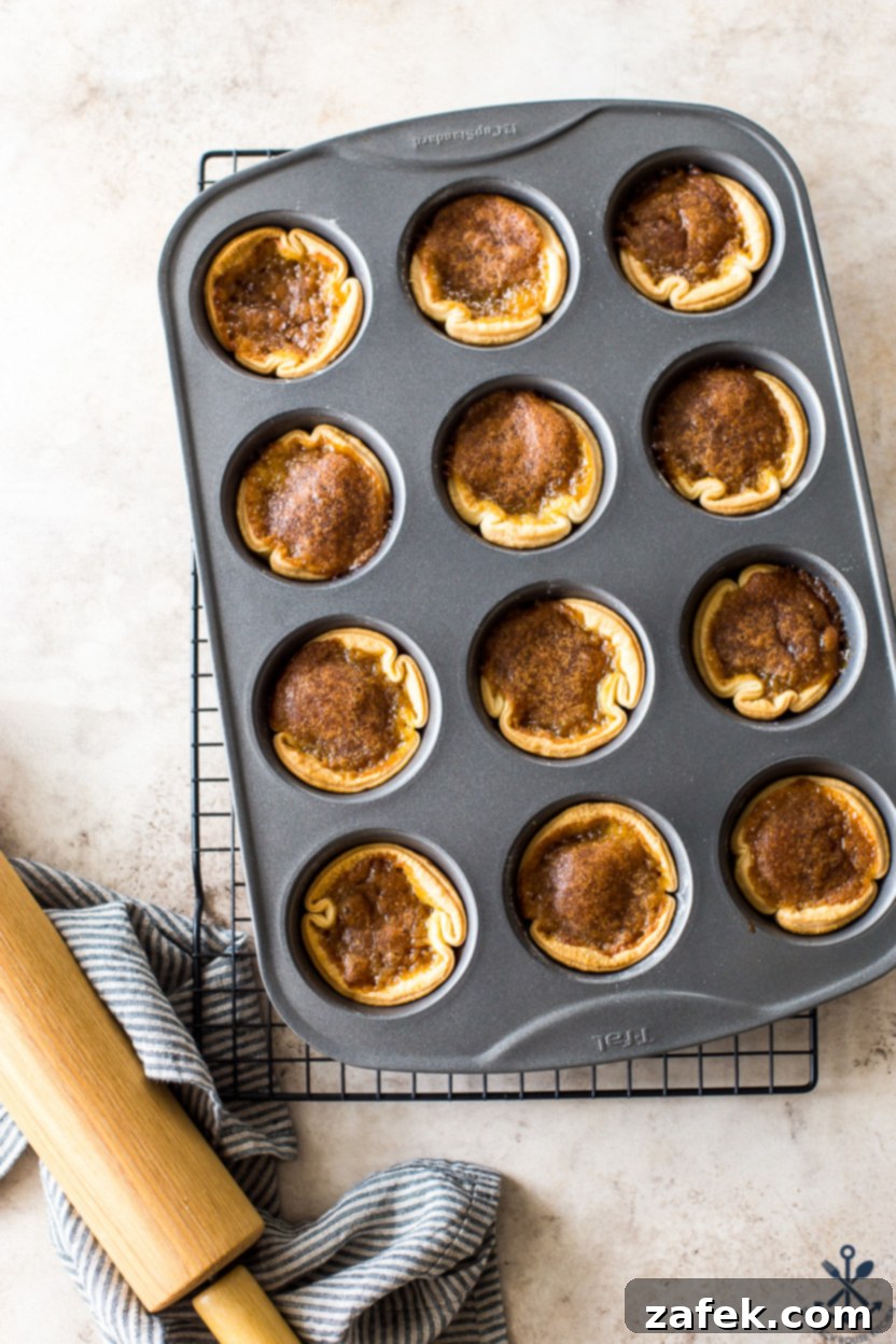 A muffin pan filled with butter tarts