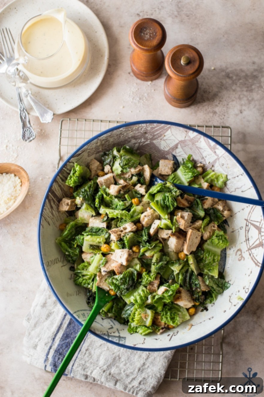 Chargrilled Chicken Caesar with Roasted Chickpea Crunch 7 An inviting overhead view of the complete Grilled Chicken Caesar Salad with Roasted Chickpeas, presented on a wire rack for cooling or serving, flanked by a stylish set of wooden salt and pepper shakers, highlighting the dish's aesthetic appeal.