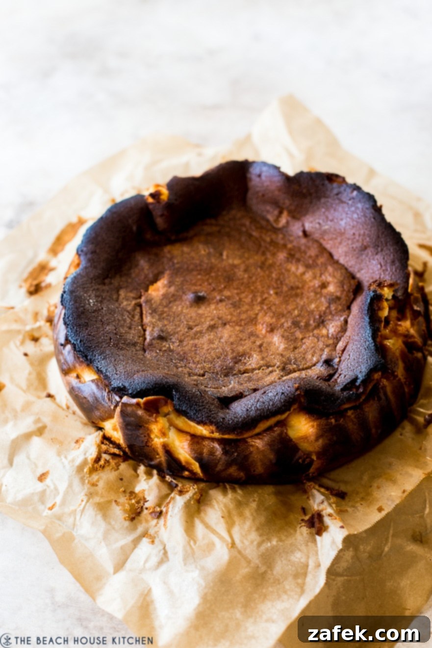 San Sebastian Burnt Cheesecake 5 A burnt basque cheesecake on brown parchment paper, ready to be served