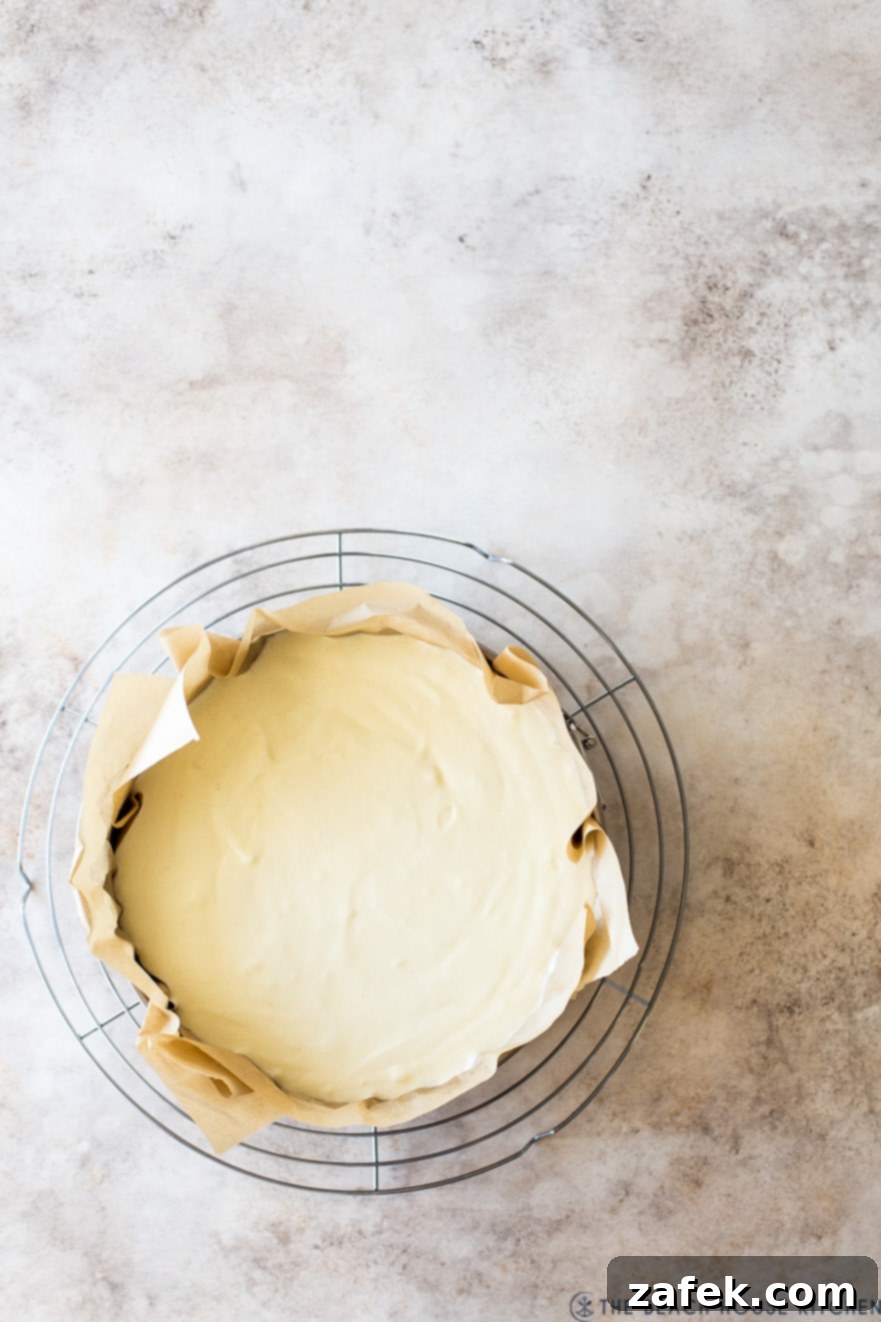 San Sebastian Burnt Cheesecake 7 Overhead photo of a prebaked cheesecake on a round wire rack, cooling down