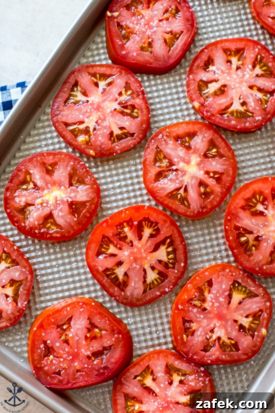 Rustic Summer Tomato Pie 3 Overhead photo of sliced tomatoes on baking sheet