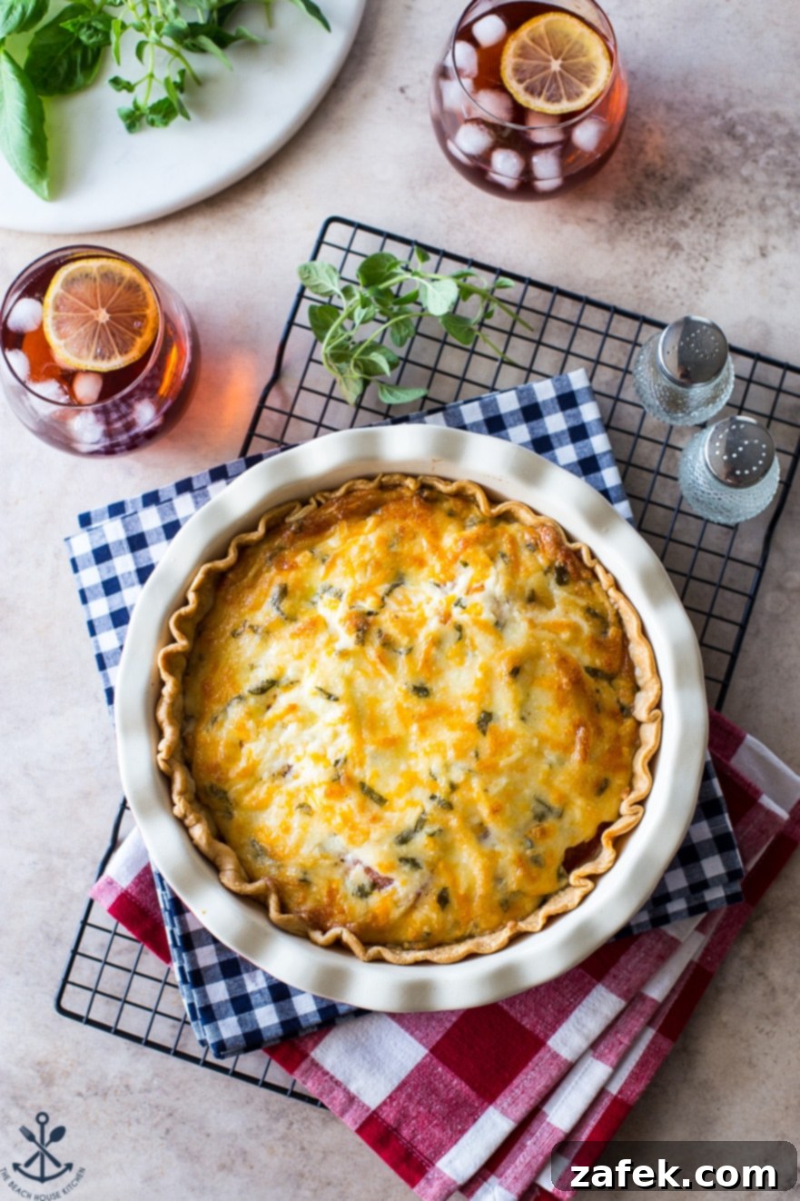Rustic Summer Tomato Pie 5 Overhead photo of a cheesy tomato pie on a checked napkin on a wire rack