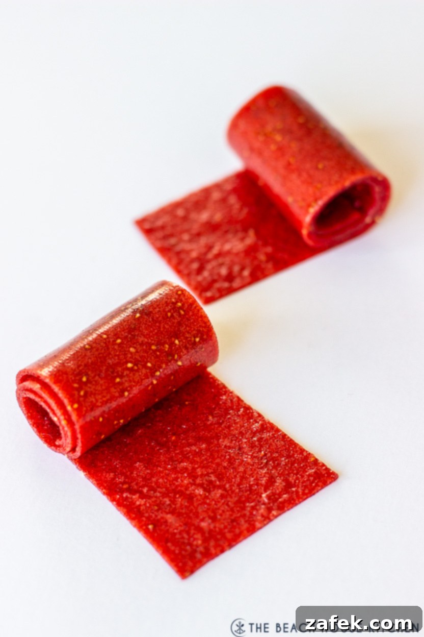 Strawberry Swirls for School Days 7 Up close photo of two strawberry fruit roll-ups, beautifully coiled and ready to eat