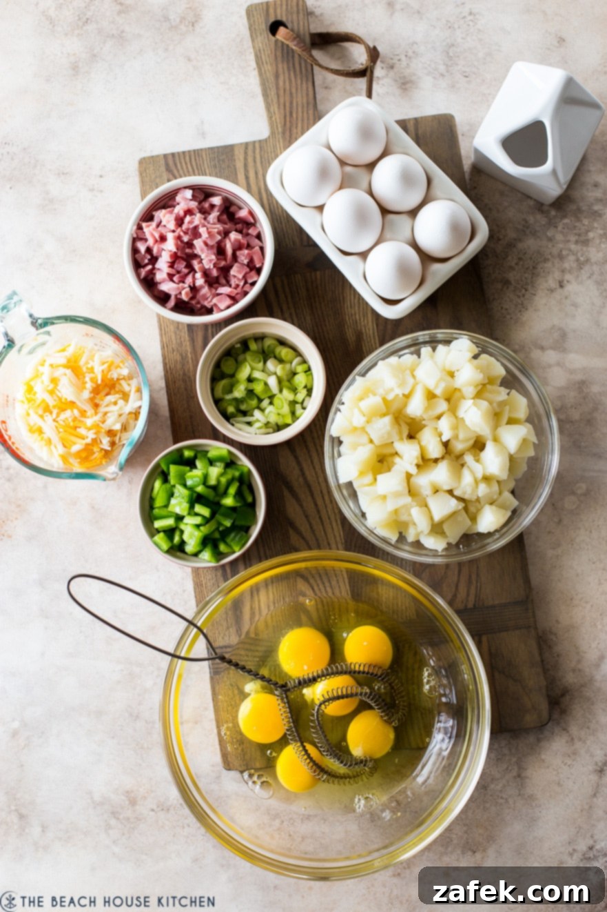 Overhead photo of ingredients for a classic Denver omelette laid out, including diced ham, chopped bell peppers, onions, and cheese