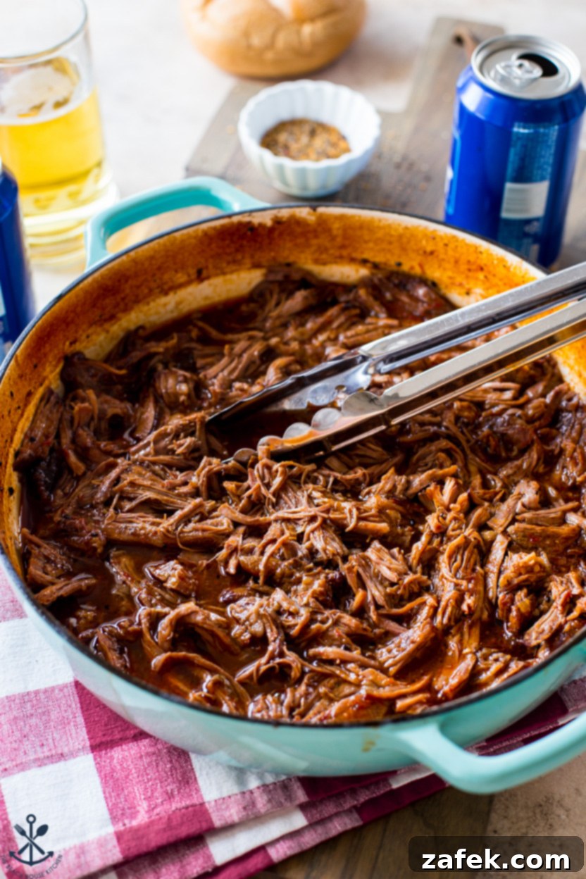 Up close photo of tender brisket in a skillet