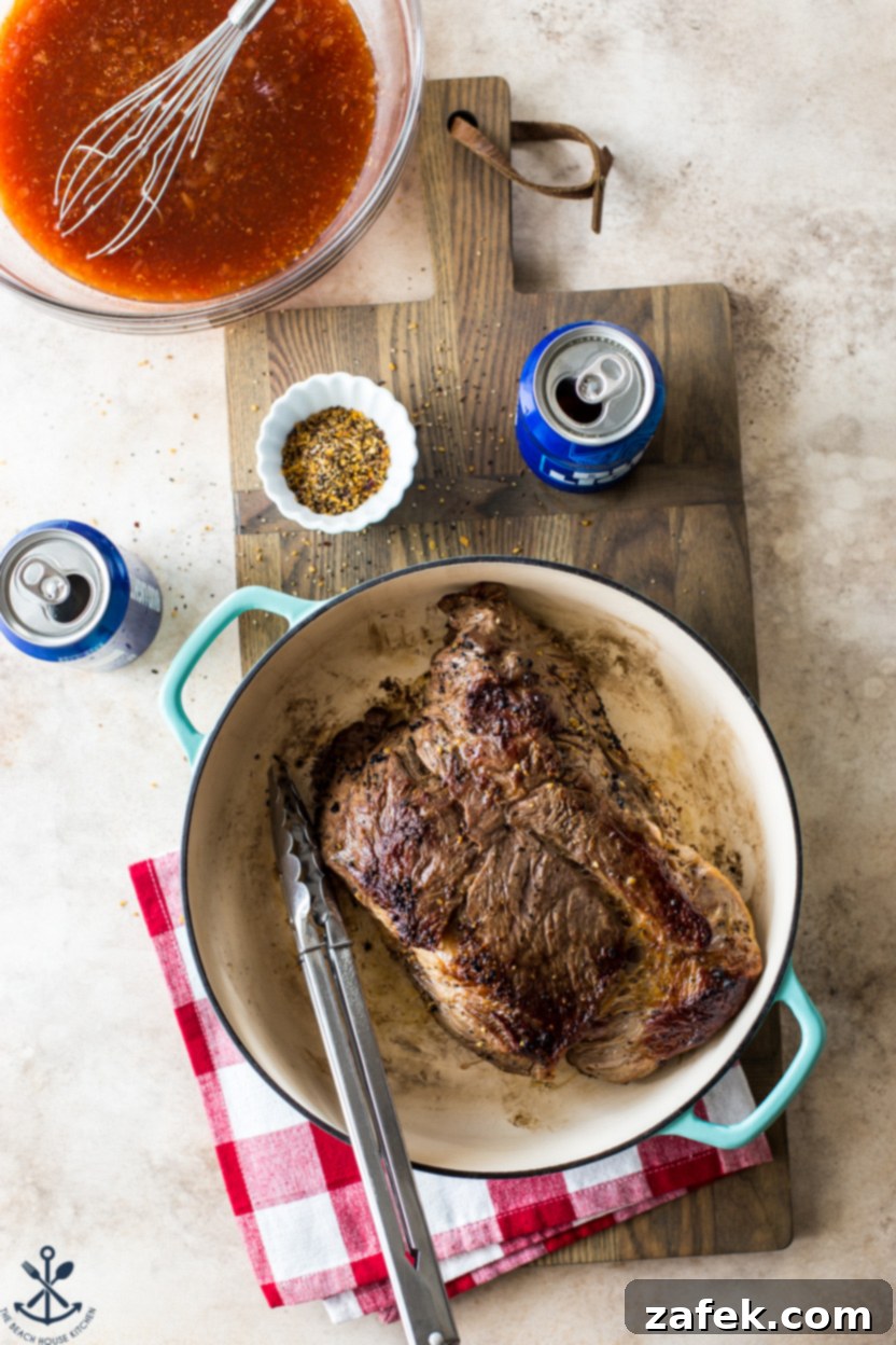 Overhead photo of a seared chuck roast in a skillet