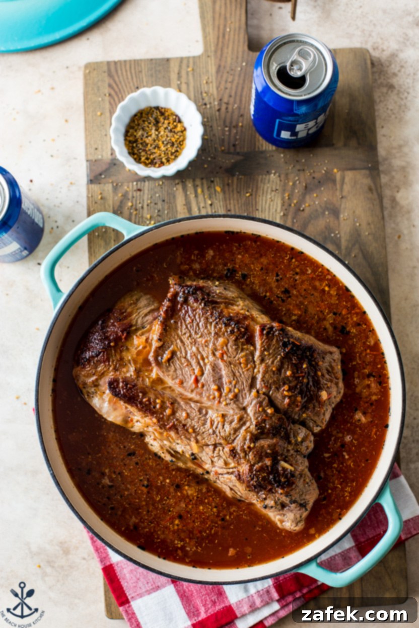 Overhead photo of a chuck roast with gravy in a skillet