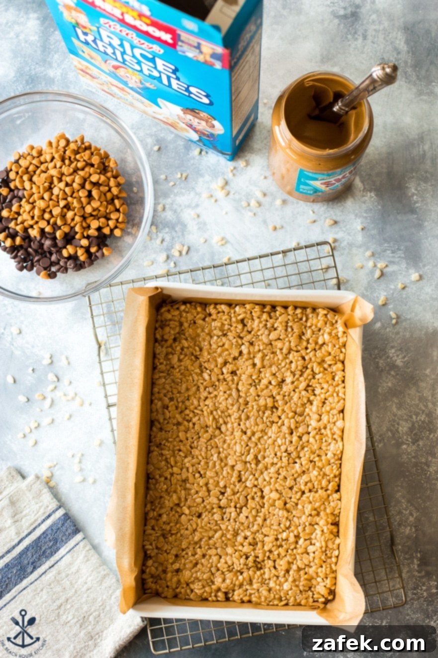 Sweet and Salty Peanut Butter Crunch Bars 3 A close-up shot of individual Scotcheroo bars with their distinct layers of crispy base and shiny chocolate-butterscotch topping