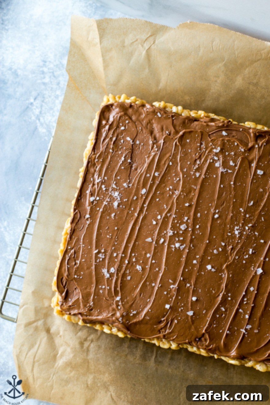 Sweet and Salty Peanut Butter Crunch Bars 6 A perfectly cut Scotcheroo bar, showcasing the distinct layers of crispy peanut butter base and the smooth, marbled chocolate-butterscotch topping