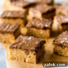 Sweet and Salty Peanut Butter Crunch Bars 8 A vibrant, close-up shot of several Scotcheroos, highlighting their rich chocolate and butterscotch swirl