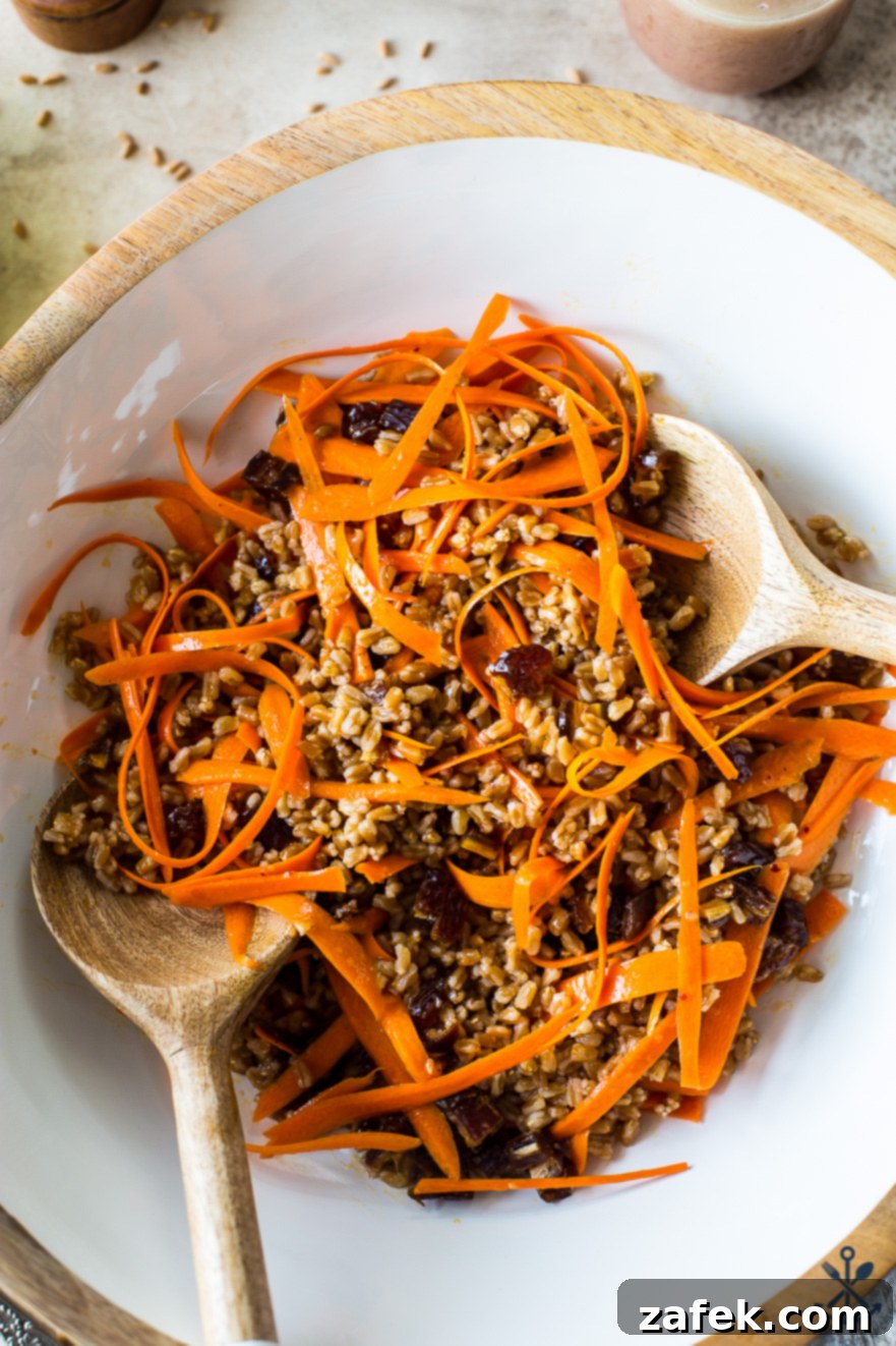 Farro and Carrot Salad with Maple-Date Vinaigrette 6 Up close overhead photo of a freshly prepared Carrot Farro Salad, showing the texture of the farro, the vibrant carrots, and the soft dates, all coated in the maple vinaigrette.