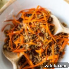 Farro and Carrot Salad with Maple-Date Vinaigrette 7 A top-down shot of the vibrant Carrot Farro Salad, rich in color and texture, presented in a stylish white bowl.