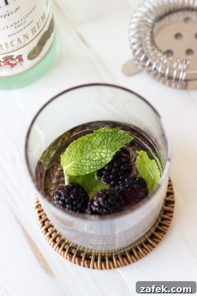 Midnight Bramble Refresher 4 Ingredients for a Blackberry Mojito laid out, including fresh blackberries, mint, lime, and rum