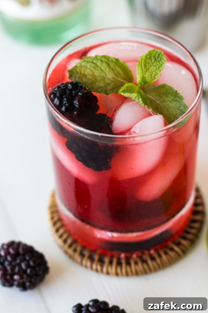 Midnight Bramble Refresher 6 Two glasses of Blackberry Mojito, one with ingredients being muddled and the other ready to serve