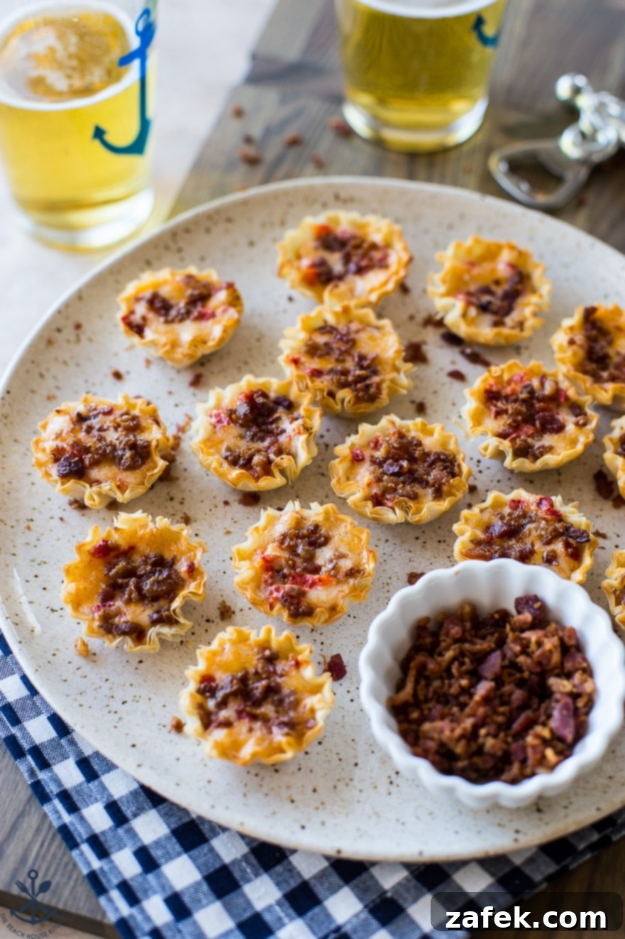 Bacon Pimento Cheese Poppers 3 A plate of bacon pimeto cheese bites on a plate with a small bowl of bacon bits