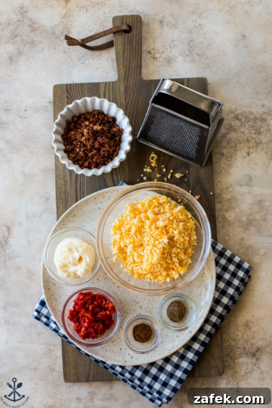 Bacon Pimento Cheese Poppers 5 Overhead photo of ingredients for bacon pimento cheese bites on a wooden board with a grater