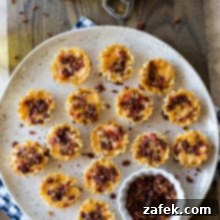 Bacon Pimento Cheese Poppers 8 Overhead photo of bacon pimento cheese bites on a plate with a glass of beer and a can opener on a wooden board