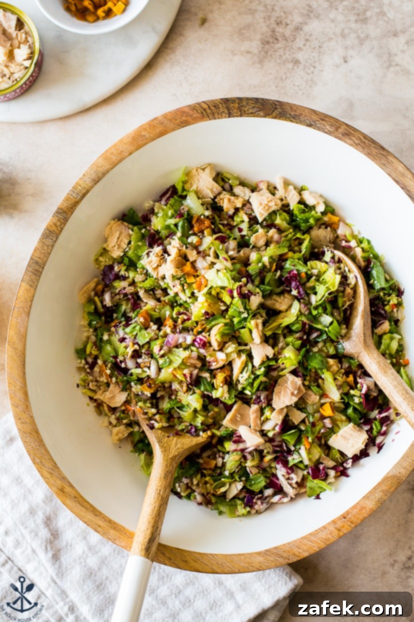 Vibrant Thai Chili Mango Tuna Chopped Salad in a bowl, showcasing fresh ingredients and a rich dressing.