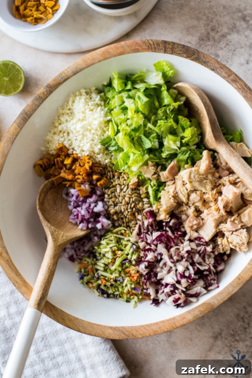 Close-up overhead shot of a perfectly mixed Thai Chili Mango Tuna Chopped Salad, ready to be served.