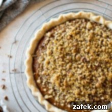 Sweet Potato Pie, Crowned with Pecans 9 Overhead photo of Sweet Potato Pie with Pecan Topping on a round wire rack