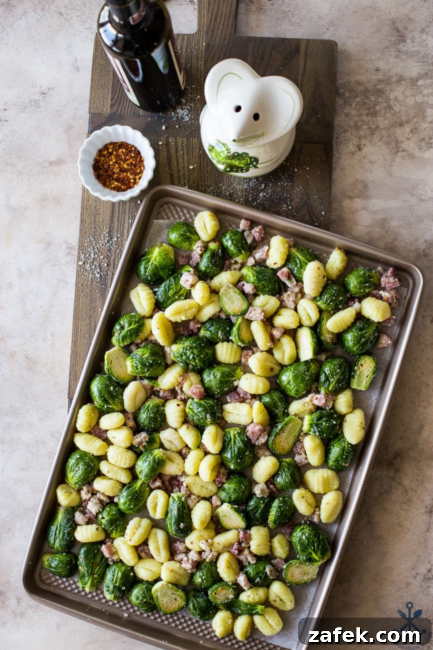 One-Pan Gnocchi Feast with Pancetta and Roasted Brussels 5 Pre-baked Gnocchi with veggies and pancetta on a baking sheet, glistening with olive oil and spices