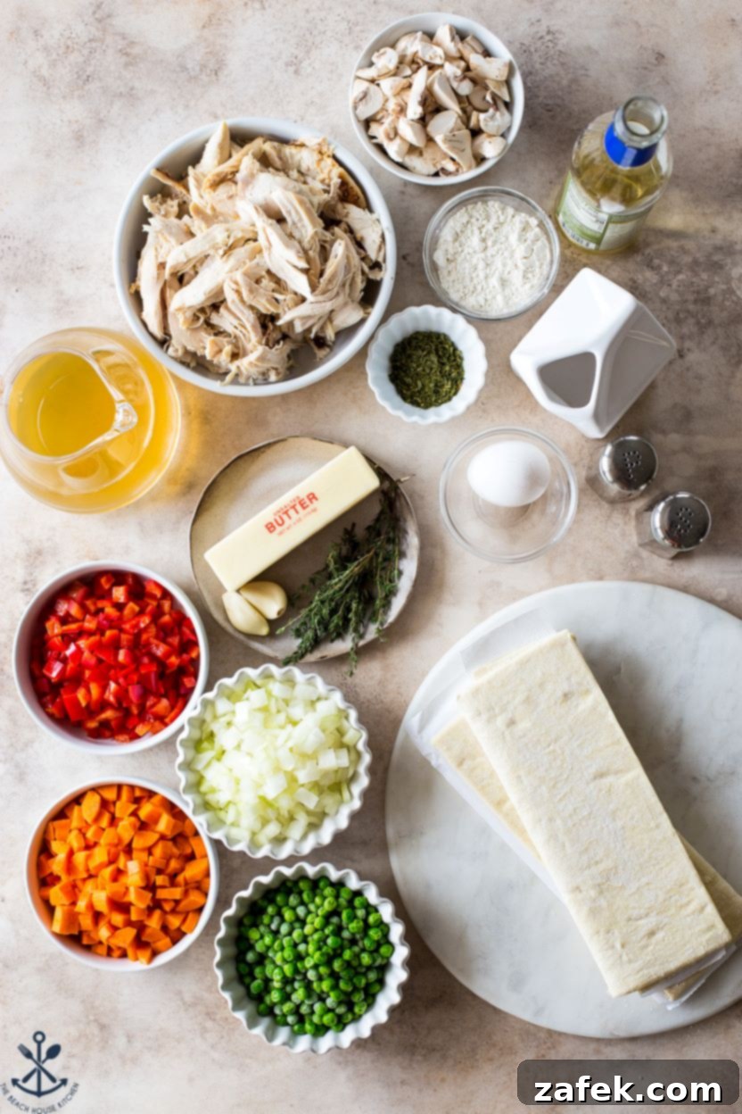 Flaky Puff Chicken Pot Pie 4 An overhead view of a selection of fresh ingredients neatly arranged on a rustic wooden surface, showcasing carrots, onions, red pepper, mushrooms, peas, chicken, and a sheet of puff pastry – all essential components for a homemade chicken pot pie.