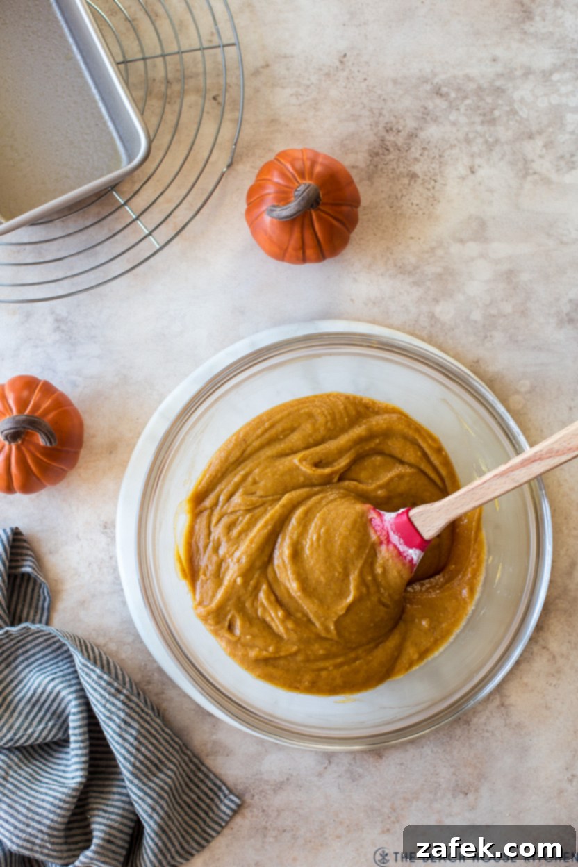 Cozy Maple Kissed Pumpkin Bread 6 An overhead photo of the perfectly mixed pumpkin bread batter in a clear glass bowl, ready for the loaf pan.
