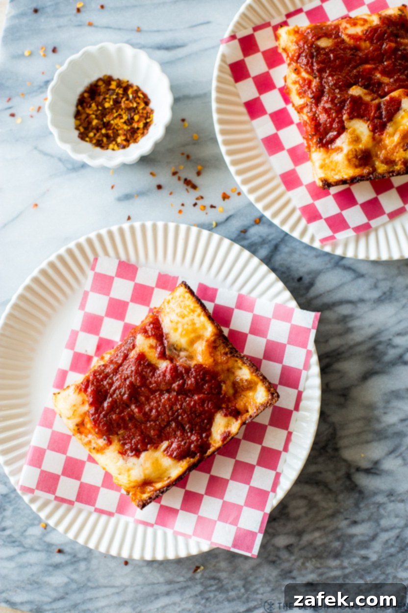 Overhead photo of a slice of Detroit-Style pizza on a plate