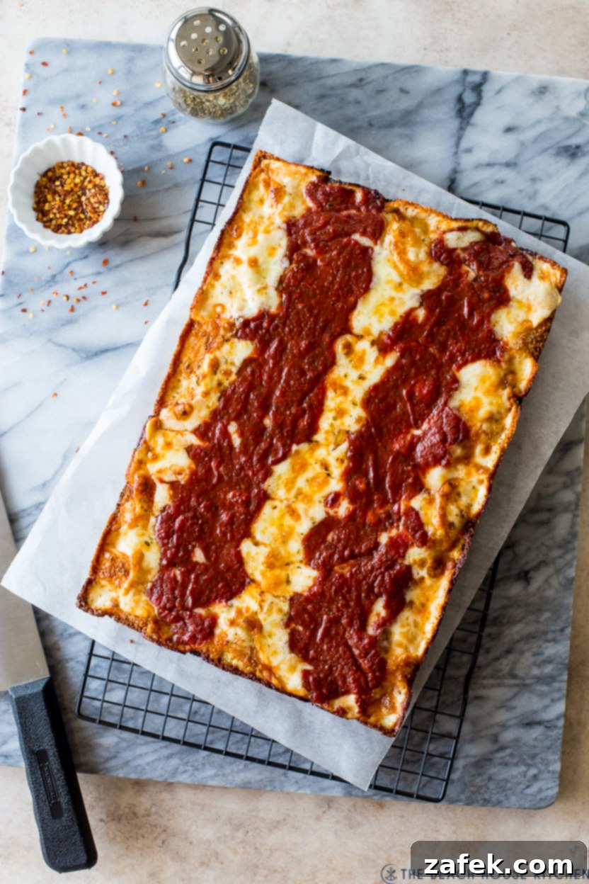 Overhead photo of a pre-cut Detroit-Style pizza ready to be served