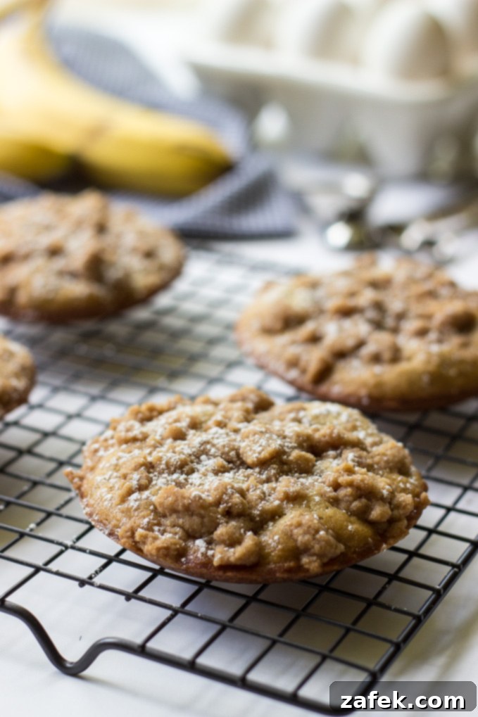 Banana Crumb Cake Muffin Tops - Golden brown muffin tops with a generous streusel topping.
