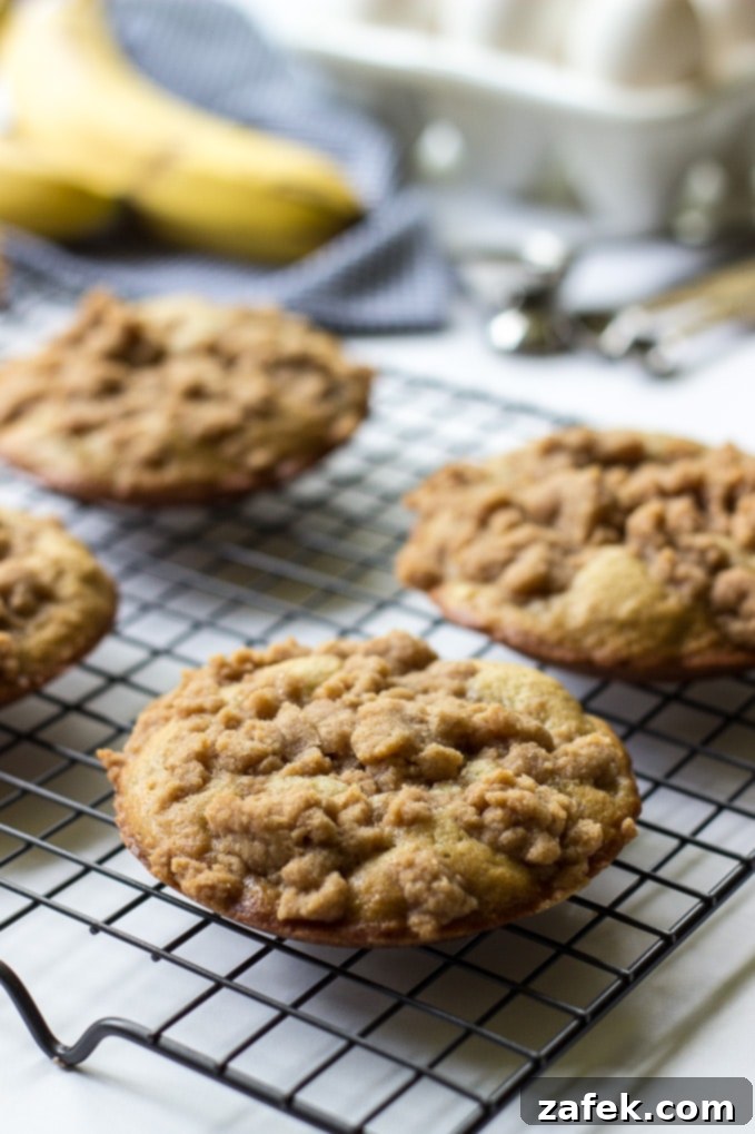 Banana Crumb Cake Muffin Tops - Overhead shot with several muffin tops on a cooling rack.