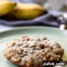 A perfectly baked Banana Crumb Cake Muffin Top on a white plate, ready to be enjoyed.